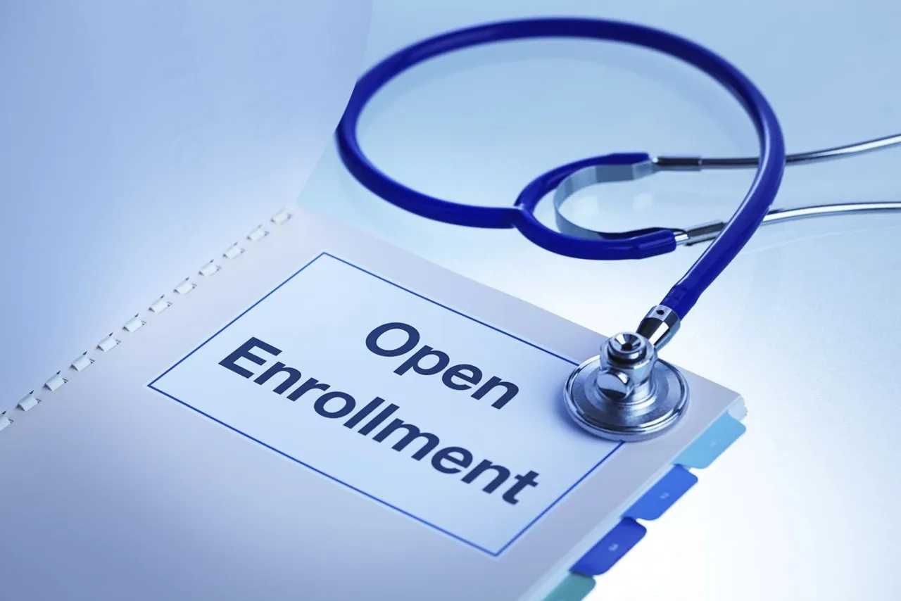 Open enrollment written on a file with stethoscope