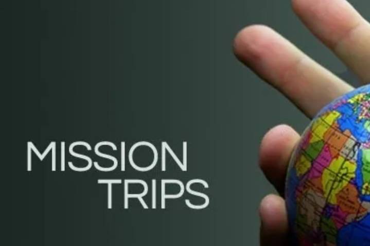 Mission trips poster with hand holding a globe
